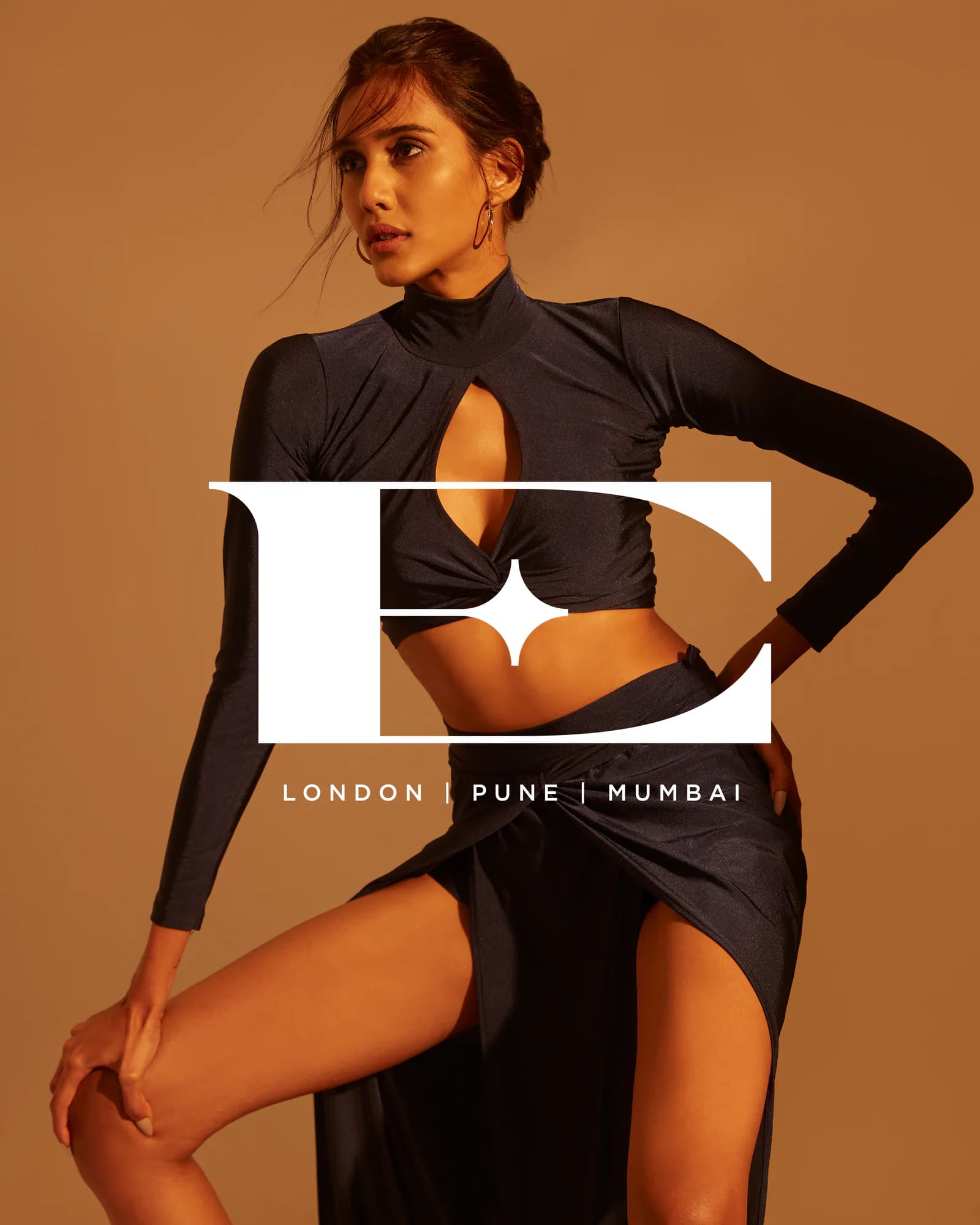 Campaign frame with the Elysian monogram set over a styled editorial portrait