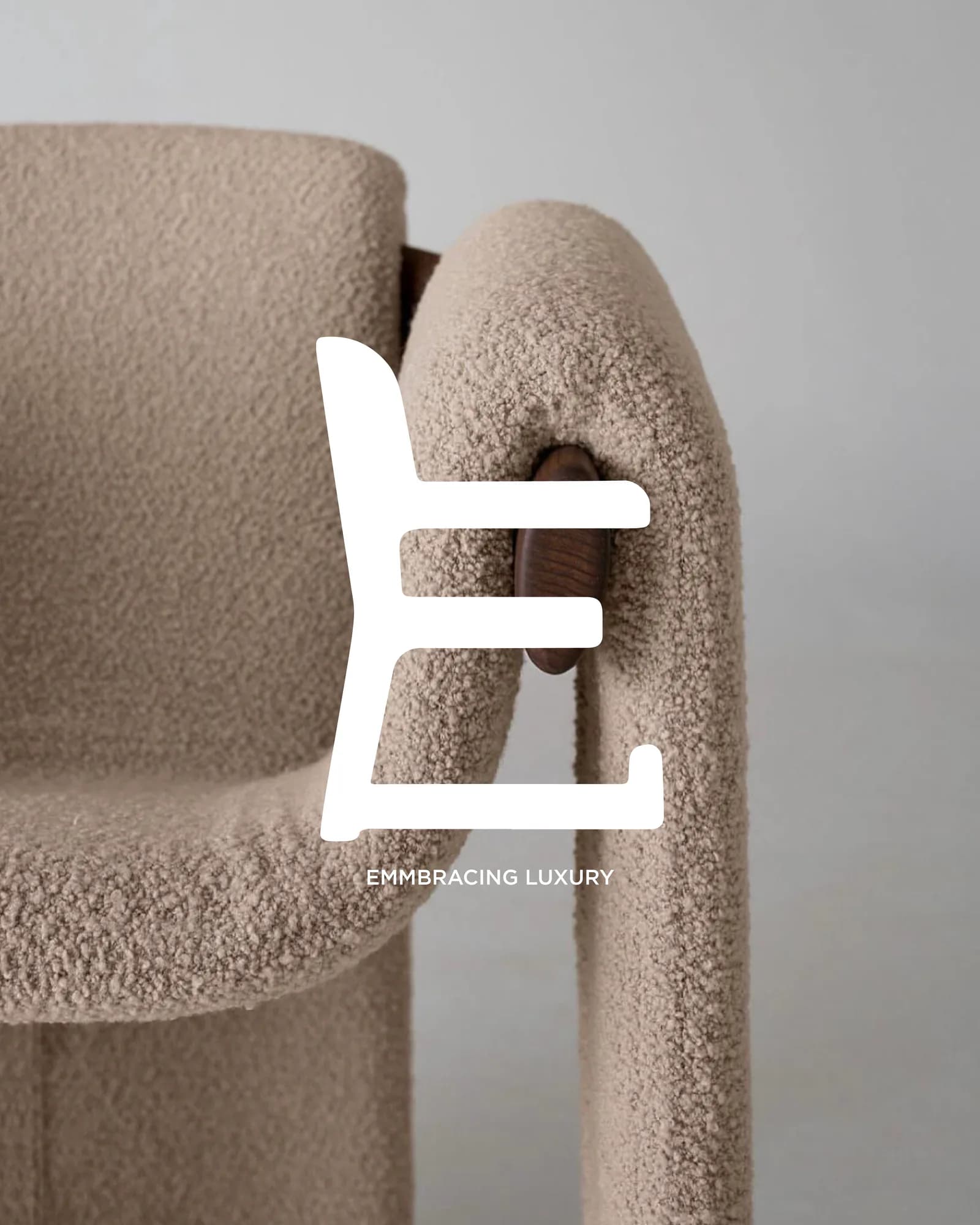 The Ellli monogram set over a bouclé lounge chair